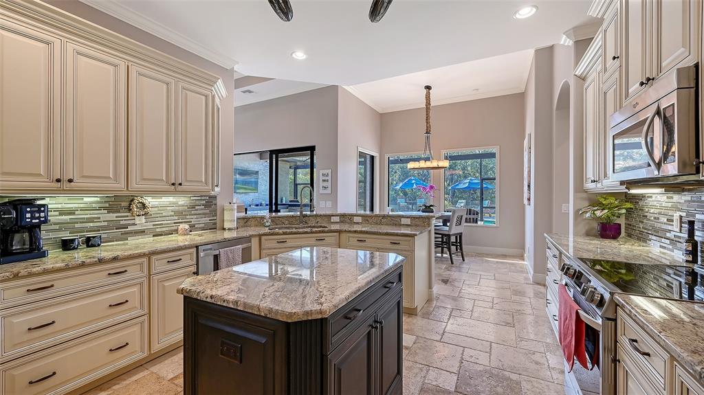 15425 Mulholland Road Parrish, FL 34219 - Photo 27 of 67 a kitchen with stainless steel appliances granite countertop a sink and a stove
