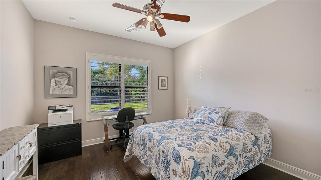 15425 Mulholland Road Parrish, FL 34219 - Photo 30 of 67 a bedroom with a bed and a chandelier