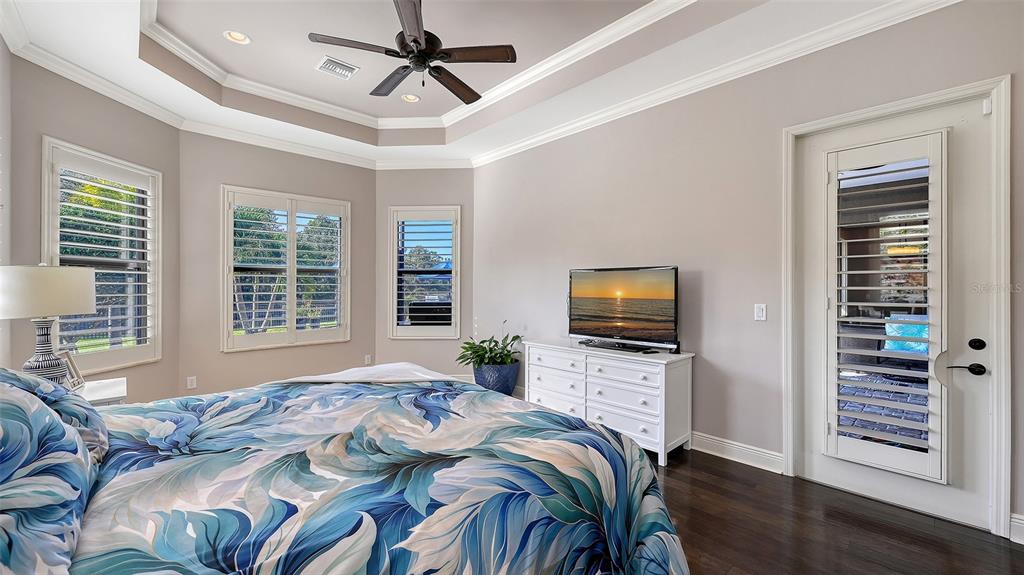 15425 Mulholland Road Parrish, FL 34219 - Photo 33 of 67 a bedroom with a bed television and a window