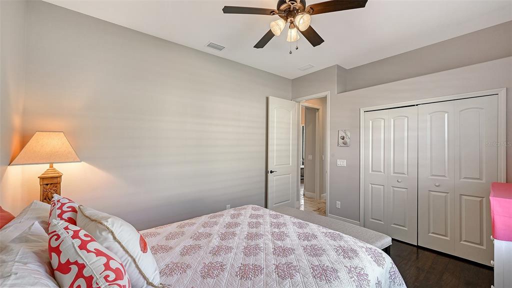 15425 Mulholland Road Parrish, FL 34219 - Photo 39 of 67 a bedroom with a bed and a lamp