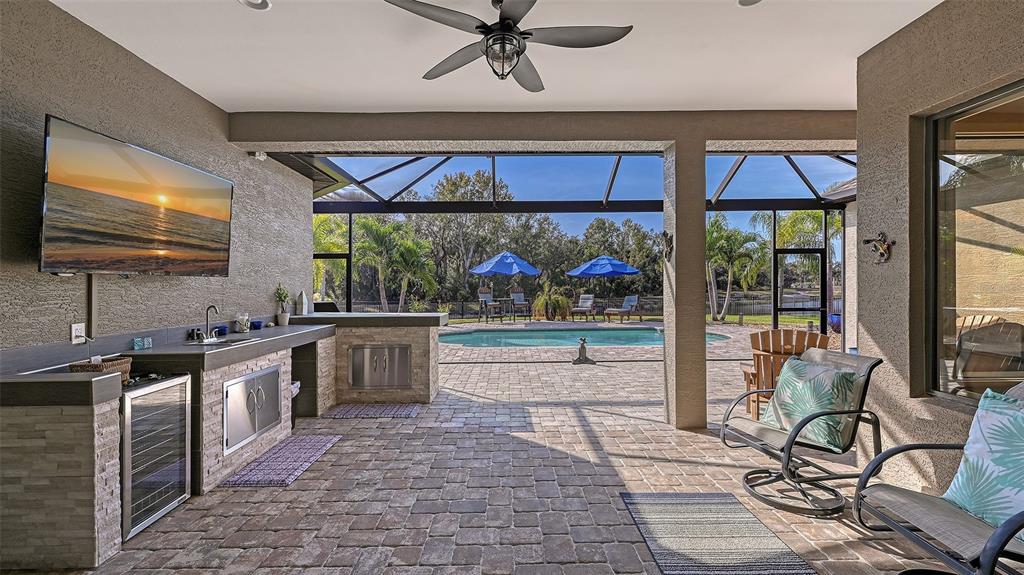 15425 Mulholland Road Parrish, FL 34219 - Photo 42 of 67 a kitchen with stainless steel appliances a stove a refrigerator a sink and white cabinets