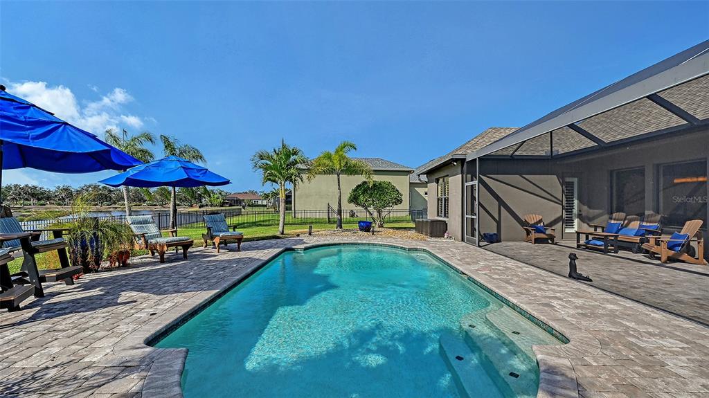 15425 Mulholland Road Parrish, FL 34219 - Photo 51 of 67 a view of a swimming pool with sitting area in front of it