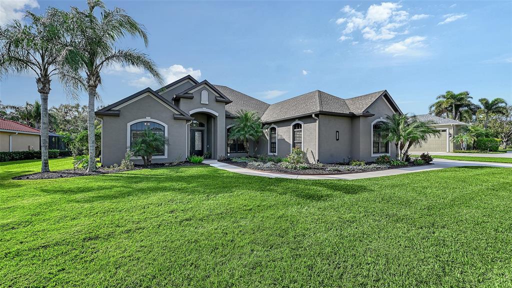 15425 Mulholland Road Parrish, FL 34219 - Photo 55 of 67 a front view of a house with garden