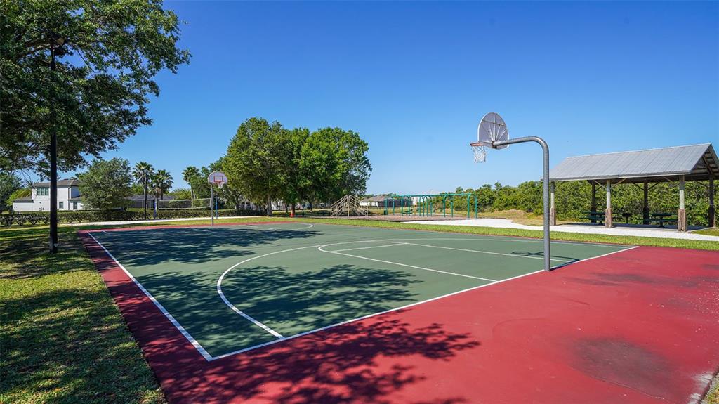 15425 Mulholland Road Parrish, FL 34219 - Photo 65 of 67 a view of a tennis ground with large trees