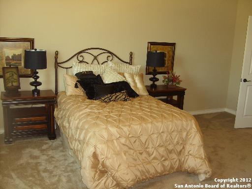 8835 Napa Landing Boerne, TX 78015 - Photo 17 of 21 a bedroom with a bed and wooden floor