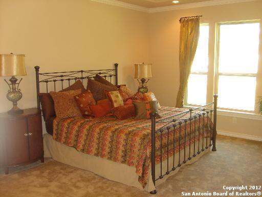 8835 Napa Landing Boerne, TX 78015 - Photo 8 of 21 a bed sitting in a bedroom next to a window