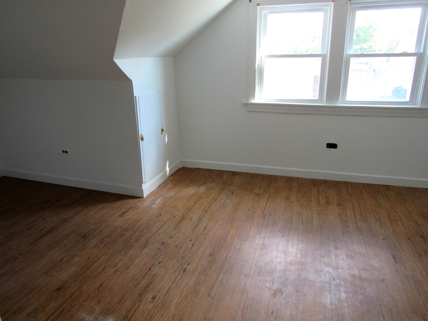 14446 Ridgeway Avenue Midlothian, IL 60445 - Photo 16 of 18 an empty room with wooden floor and windows