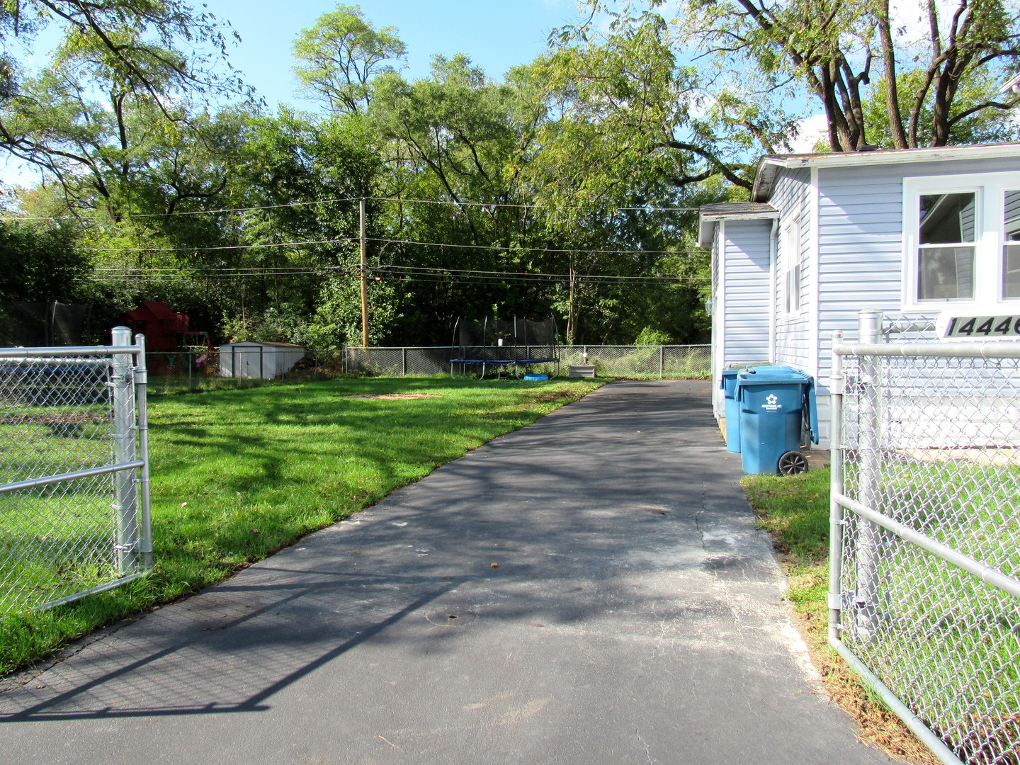 14446 Ridgeway Avenue Midlothian, IL 60445 - Photo 5 of 18 a view of a park with plants and large trees