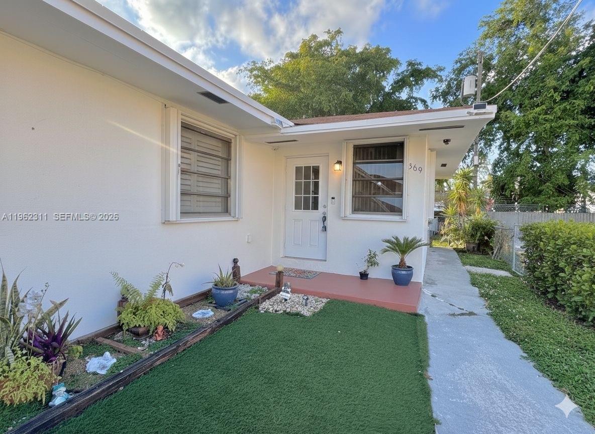 367 East 20th Street, Unit 369 Hialeah, FL 33010 - Photo 1 of 10 a front view of a house with a yard