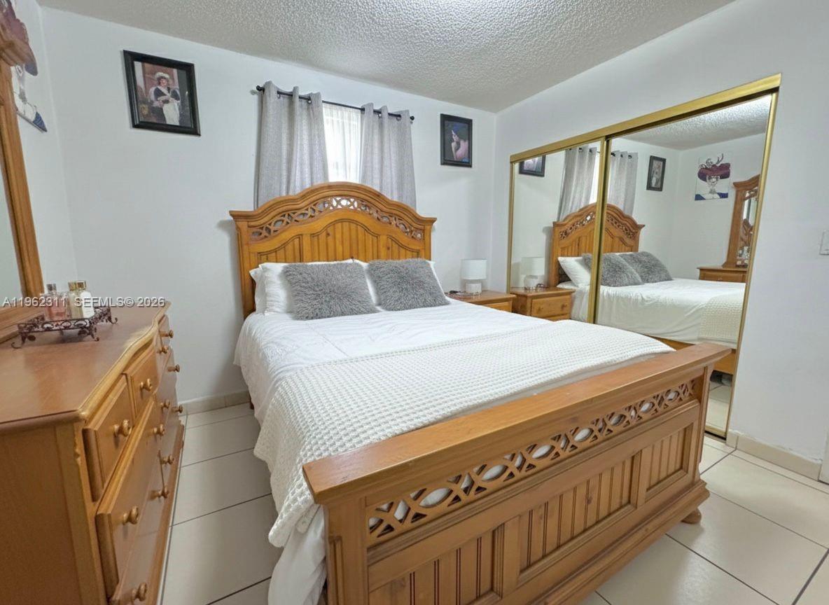 367 East 20th Street, Unit 369 Hialeah, FL 33010 - Photo 7 of 10 a bedroom with a bed and a closet