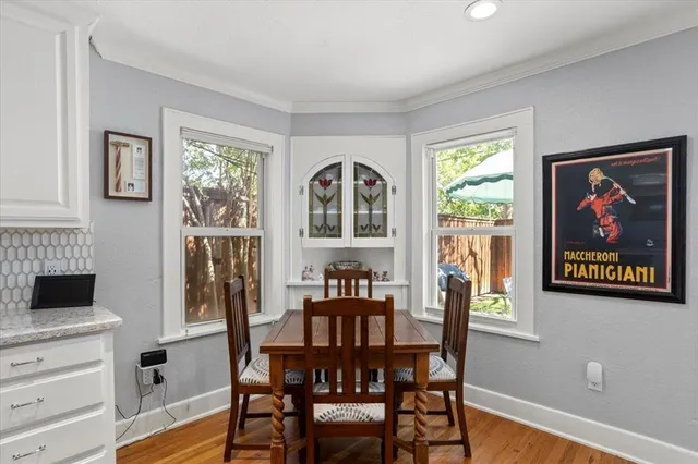 a view of a dining room with furniture window and wooden floor