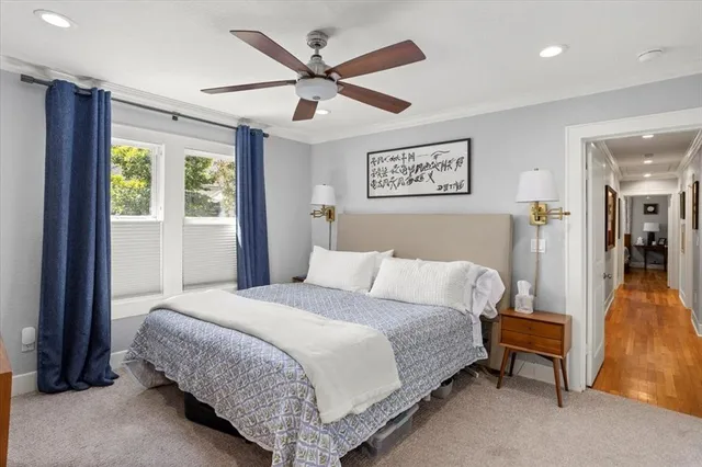 a spacious bedroom with a bed and a chandelier
