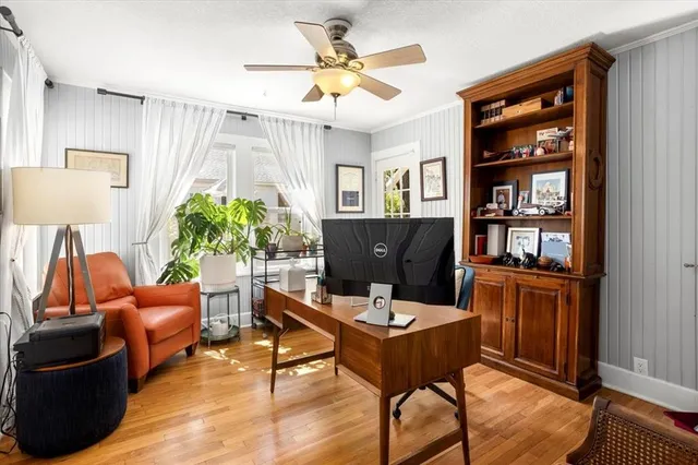 a work room with furniture lamp and window
