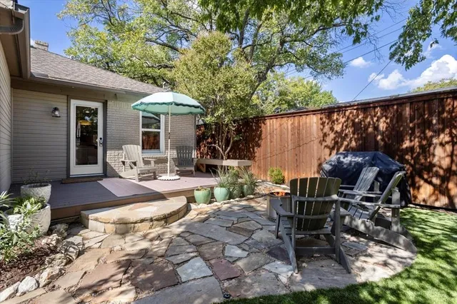 a view of a patio with table and chairs next to a yard
