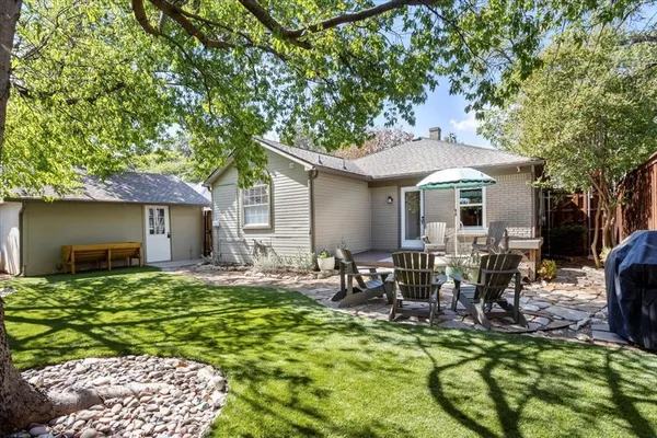 a view of a house with backyard porch and sitting area
