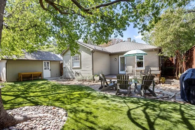 a view of a house with backyard porch and sitting area