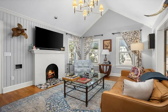 a living room with furniture a flat screen tv and a fireplace