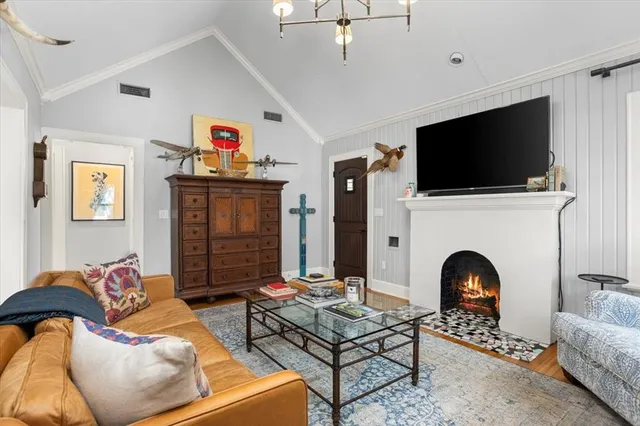 a living room with furniture fireplace and flat screen tv