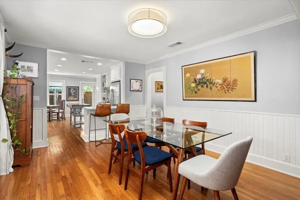 a view of a dining room with furniture and wooden floor
