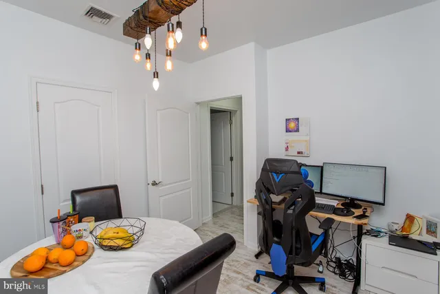 a view of a workspace with furniture and gym equipment