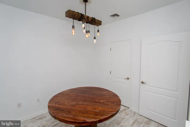 a view of a room with a wooden floor and windows