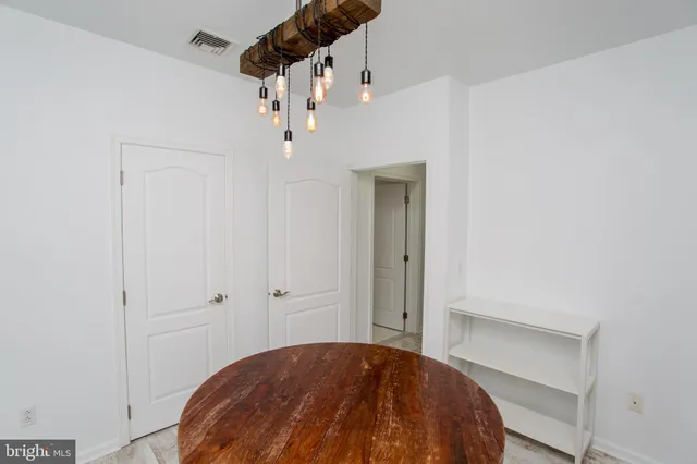 a view of a bedroom with wooden floor