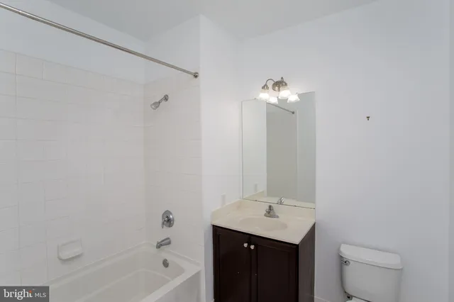 a bathroom with a bath tub sink mirror and vanity