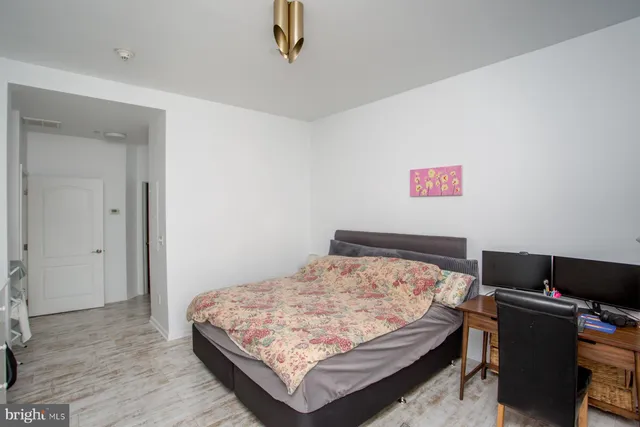 a bedroom with a bed a dresser and a window