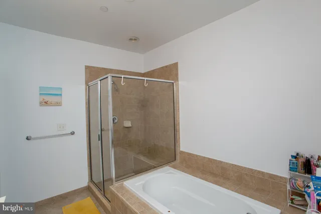 a bedroom with a bed a flat screen tv and a window