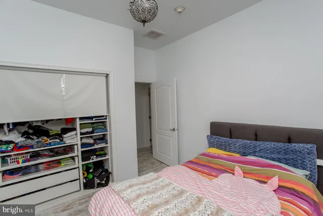 a bedroom with a bed and dresser