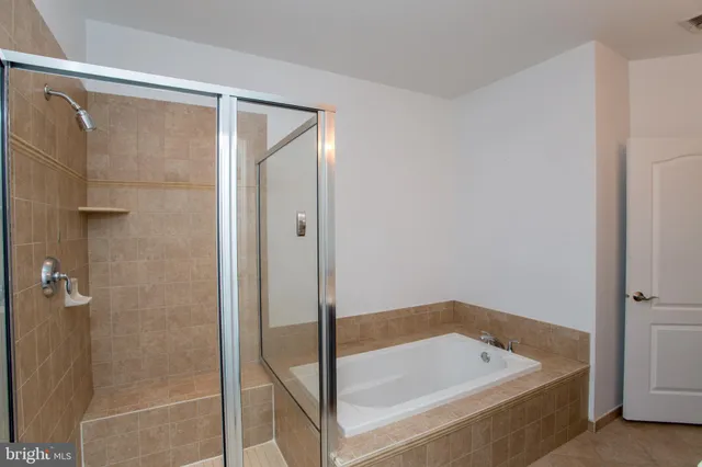 a bathroom with a shower and a glass door