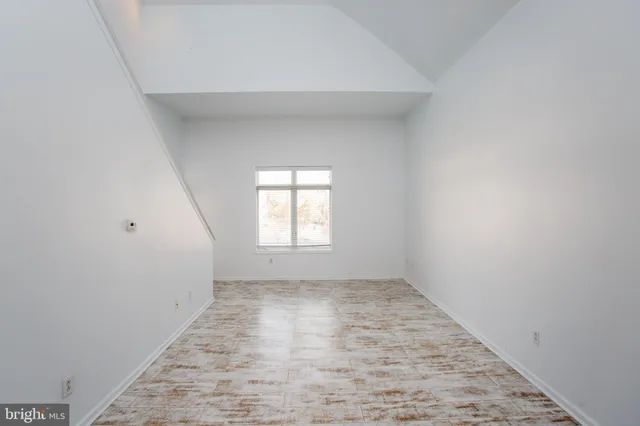 a kitchen with stainless steel appliances kitchen island granite countertop a refrigerator and a stove top oven