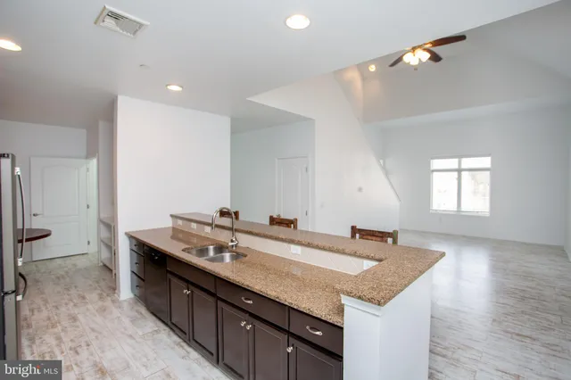 a bathroom with a sink a vanity and a large mirror