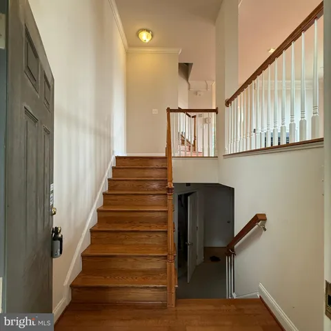 a view of entryway and hall with wooden floor