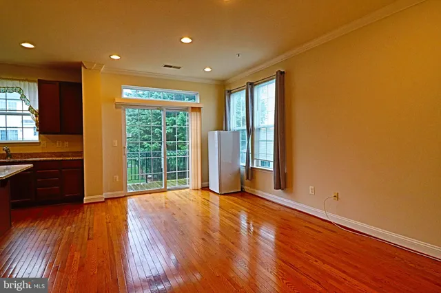 a view of a livingroom with wooden floor and a window