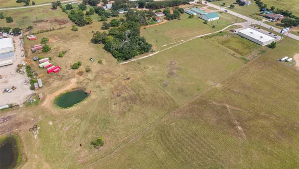 an aerial view of residential houses with yard