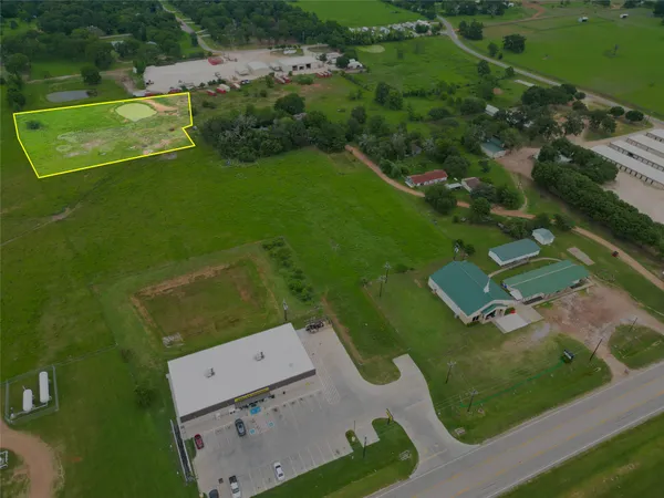 an aerial view of residential houses with outdoor space and street view