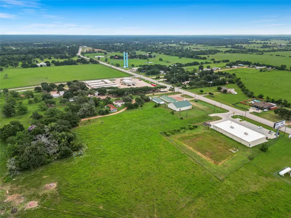 an aerial view of a houses with a yard