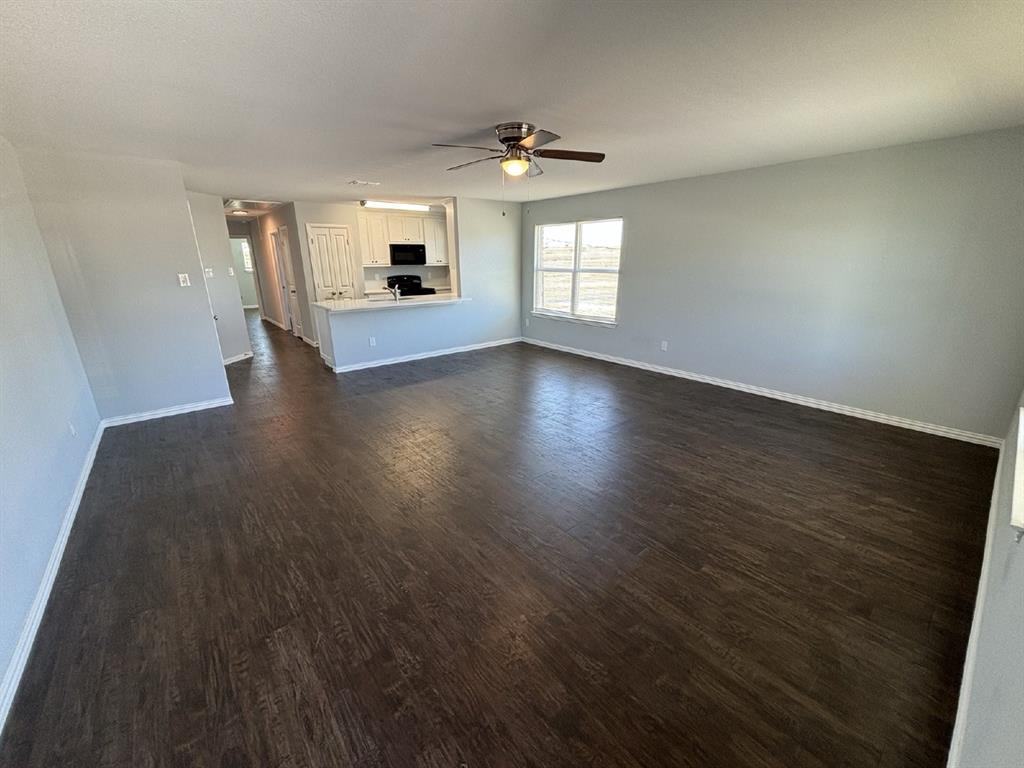 108 Arrowhead Street, Unit B Fort Worth, TX 76108 - Photo 3 of 17 wooden floor in an empty room with a window