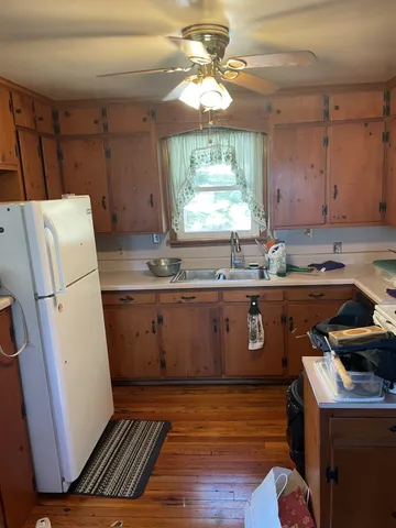 a kitchen with a sink a refrigerator and window