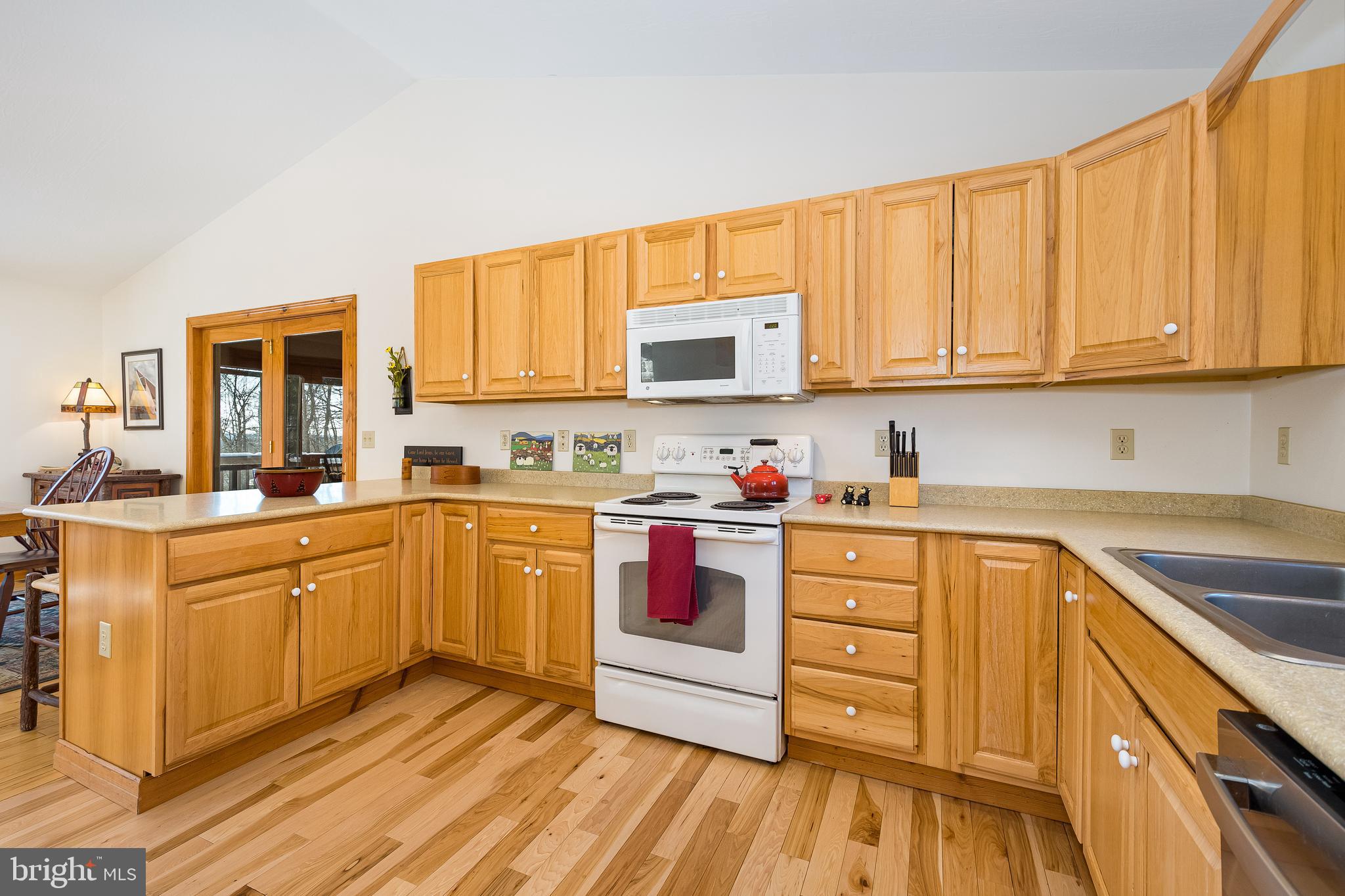 41 Wilson Circle Swanton, MD 21561 - Photo 11 of 63 a kitchen with granite countertop wooden cabinets stainless steel appliances a sink and a window