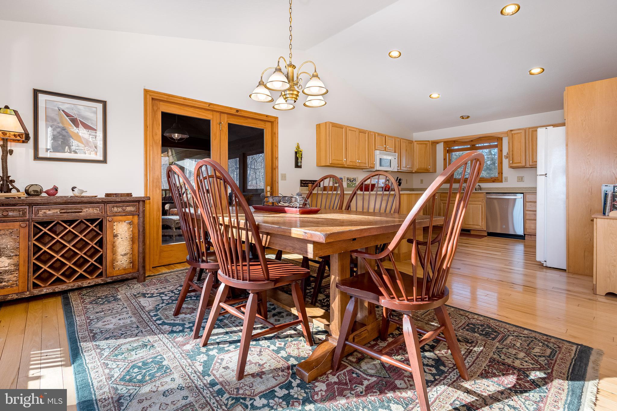 41 Wilson Circle Swanton, MD 21561 - Photo 14 of 63 a view of a dining room with furniture wooden floor and chandelier