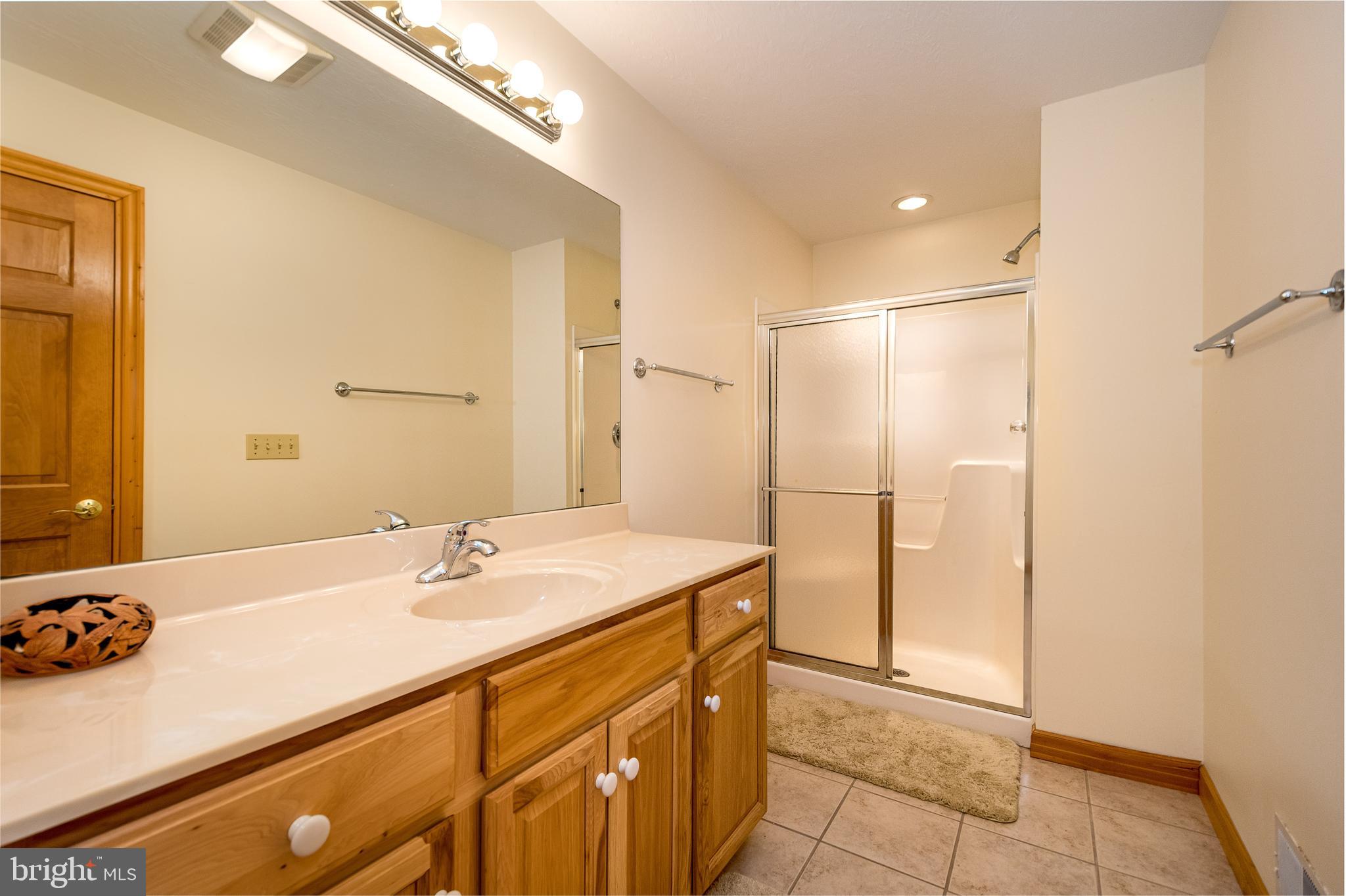 41 Wilson Circle Swanton, MD 21561 - Photo 25 of 63 a bathroom with a sink and a mirror