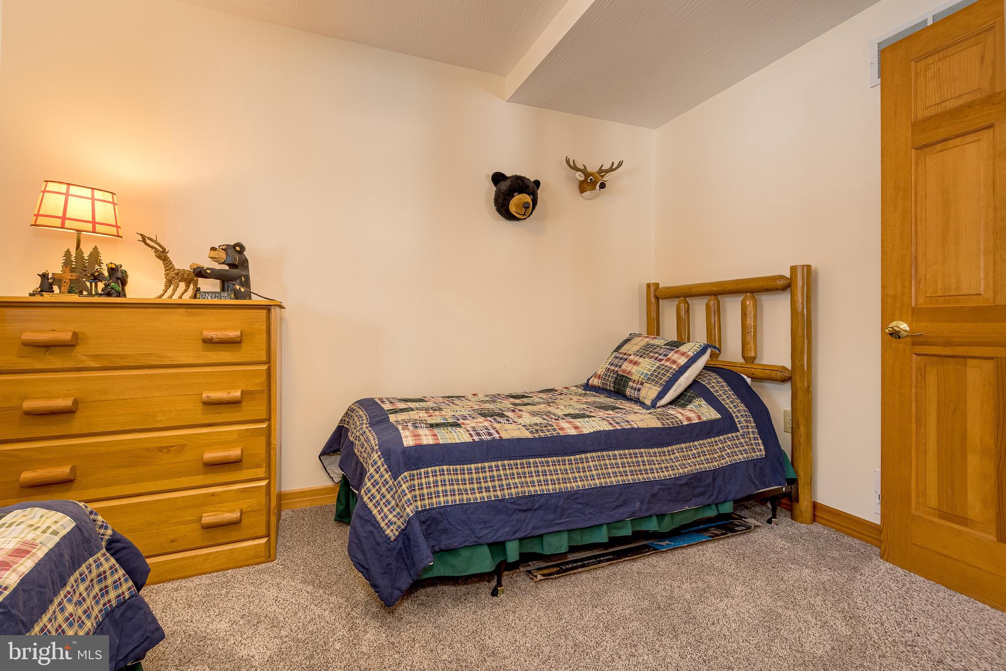 41 Wilson Circle Swanton, MD 21561 - Photo 32 of 63 a bedroom with a bed and a dresser