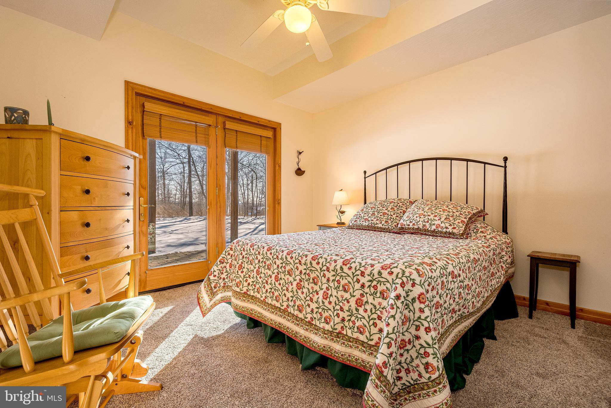 41 Wilson Circle Swanton, MD 21561 - Photo 35 of 63 a large bed sitting in a bedroom next to a window