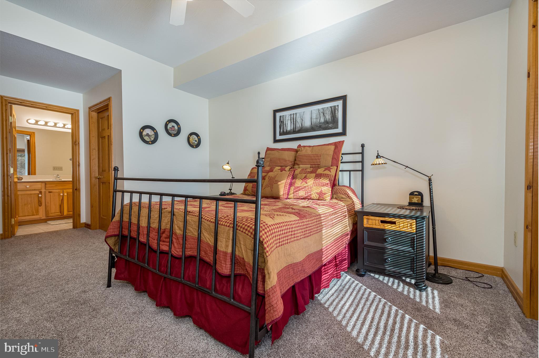 41 Wilson Circle Swanton, MD 21561 - Photo 38 of 63 a bedroom with a bed and a lamp on table