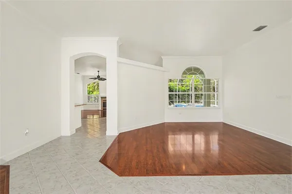 an empty room with wooden floor and a window