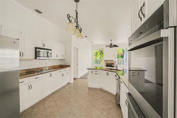a large kitchen with kitchen island granite countertop lots of counter top space