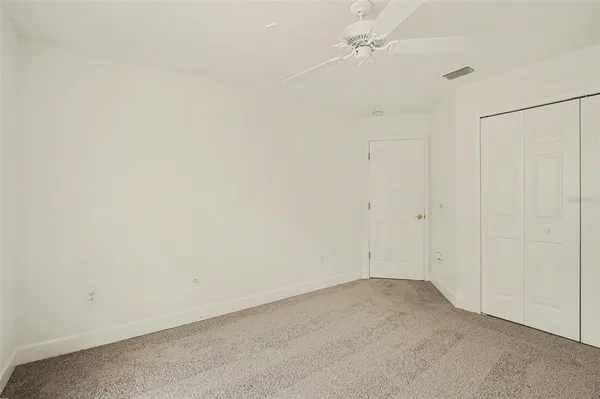 an empty room with a ceiling fan