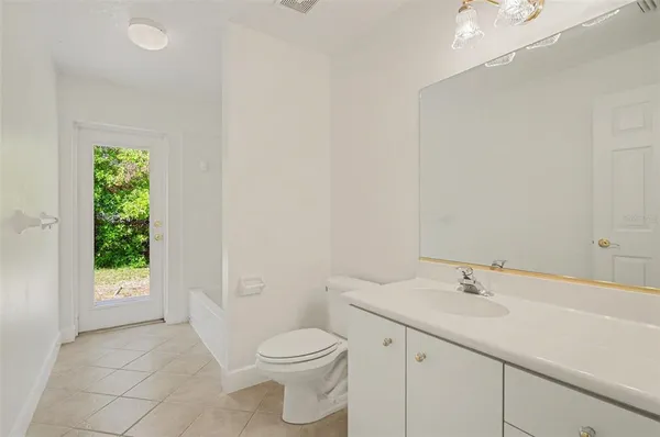 a bathroom with a sink a toilet and a window